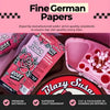 Promotional graphic for Blazy Susan Fine German Papers rose wrap. The image features a pink background with text banners at the top and bottom, showcasing the pink and red packaging of the Blazy Sugar Rose Wrap, a pink plastic paper cutter, and a tray of white toothpicks.