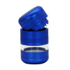 A metallic blue herb grinder with a transparent glass window, shown with its lid removed and tilted to display the grinding mechanism.