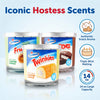 Hostess-themed candles with branding and product details on a light blue background