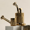 A set of golden smoking accessories, including a bowl, a pipe, and a grinder, featuring a textured diamond-patterned finish, displayed on white blocks against a light beige background.