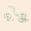 Clear glass water pipe set with a round base, curved neck, and separate mushroom-shaped mouthpiece, shown on a warm beige background.