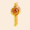 A NWTN Home translucent amber-yellow glass hand pipe with a rounded body, cylindrical neck, and matching base, shown on a plain warm beige background.