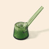 A NWTN Home translucent green glass water pipe with a ribbed, flared base and a long angled mouthpiece, shown on a solid light beige background.