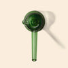 A translucent green glass NWTN Home Deco Hand Pipe, shown on a solid light beige background with a soft shadow.