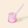 A NWTN Home translucent pink glass water pipe with a ribbed, flared base and a long angled mouthpiece, shown on a solid light beige background.