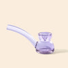 A translucent light purple glass water pipe by NWTN Home with a curved bowl and a small stem, shown on a solid pale beige background.